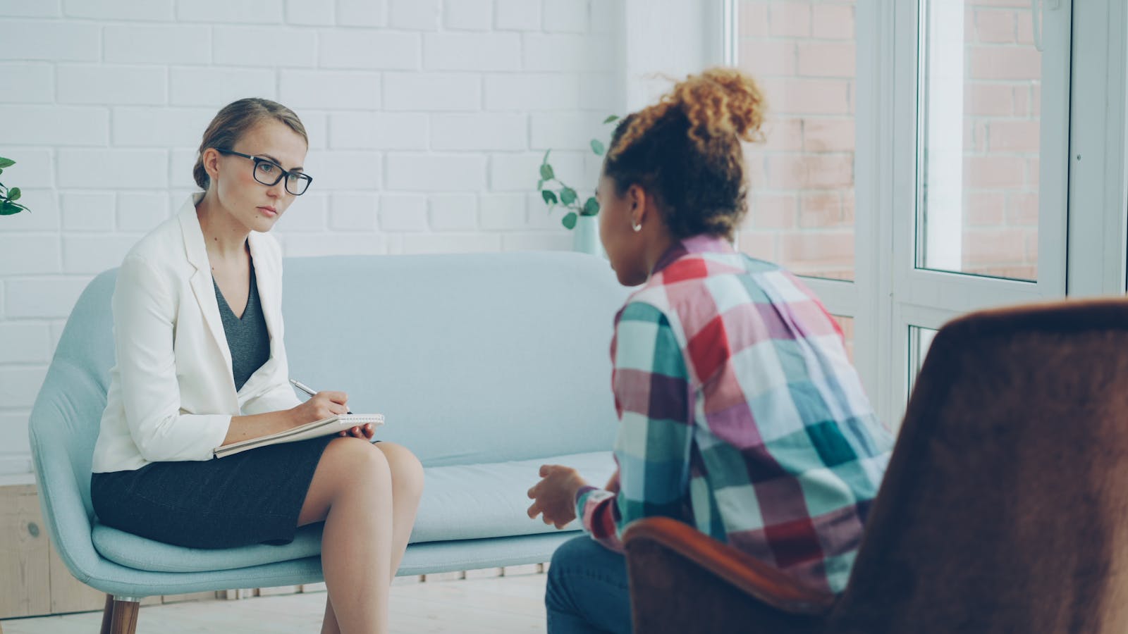 Counselor and client in conversation in a warm community clinic room